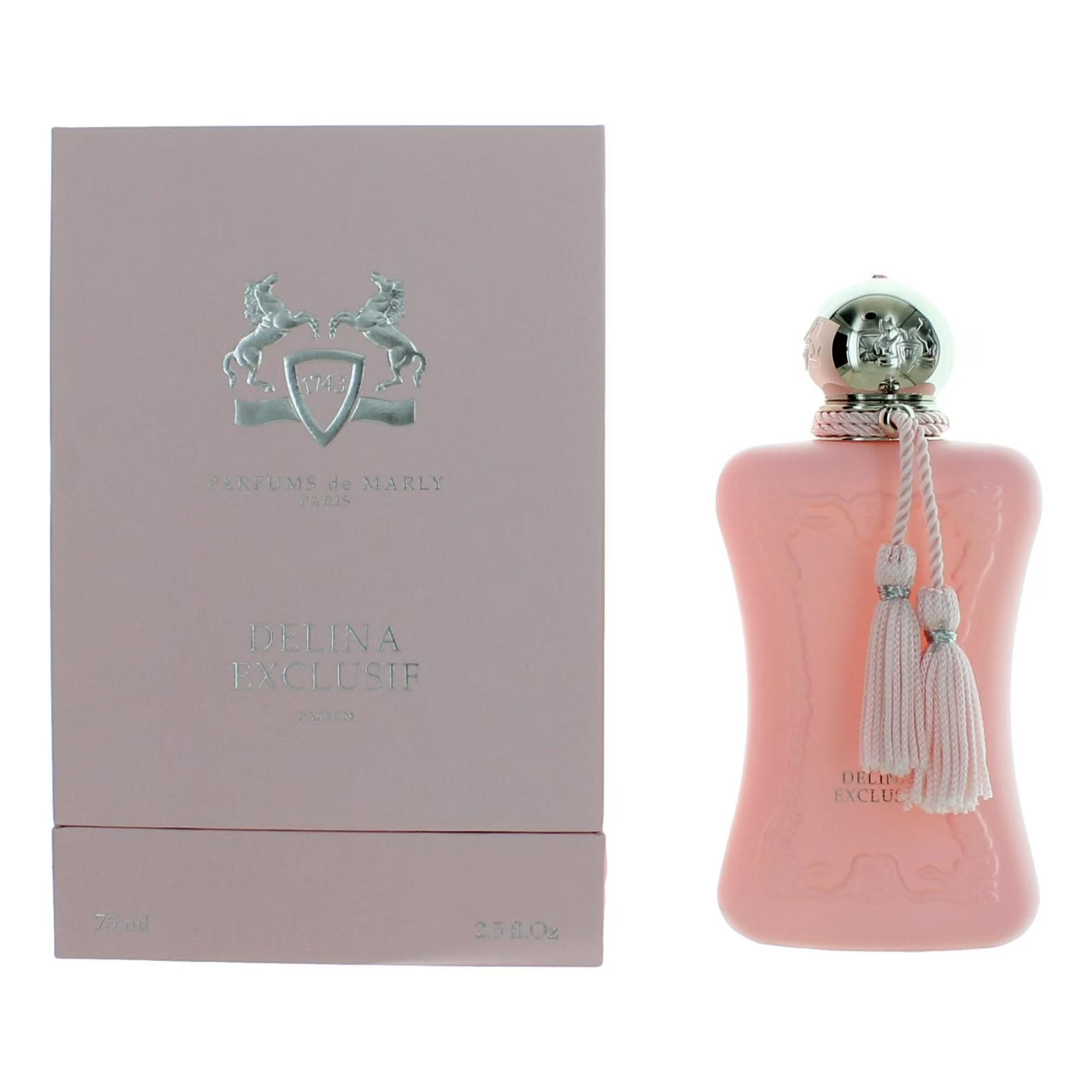 Pink perfume bottle with silver cap and tassels next to a matching box on a white background