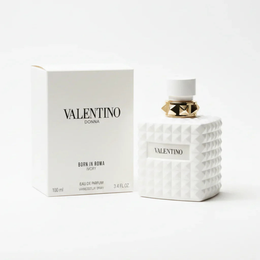 Valentino perfume bottle and packaging on a marble surface with a dark background