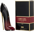 Black high-heeled shoe and Carolina Herrera 'Good Girl' perfume box on a white background