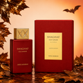 Shaghaf Oud Ahmar perfume bottle and packaging on a warm-toned background with leaves and bats.